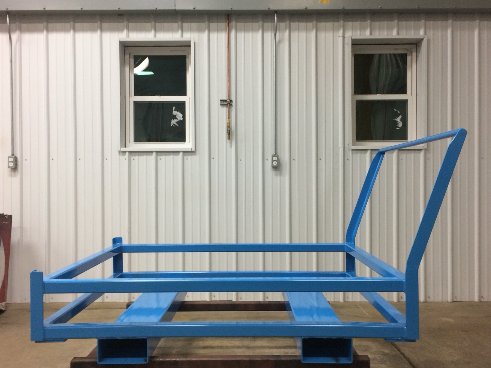 Powder-coated steel stacking rack built in the shop
